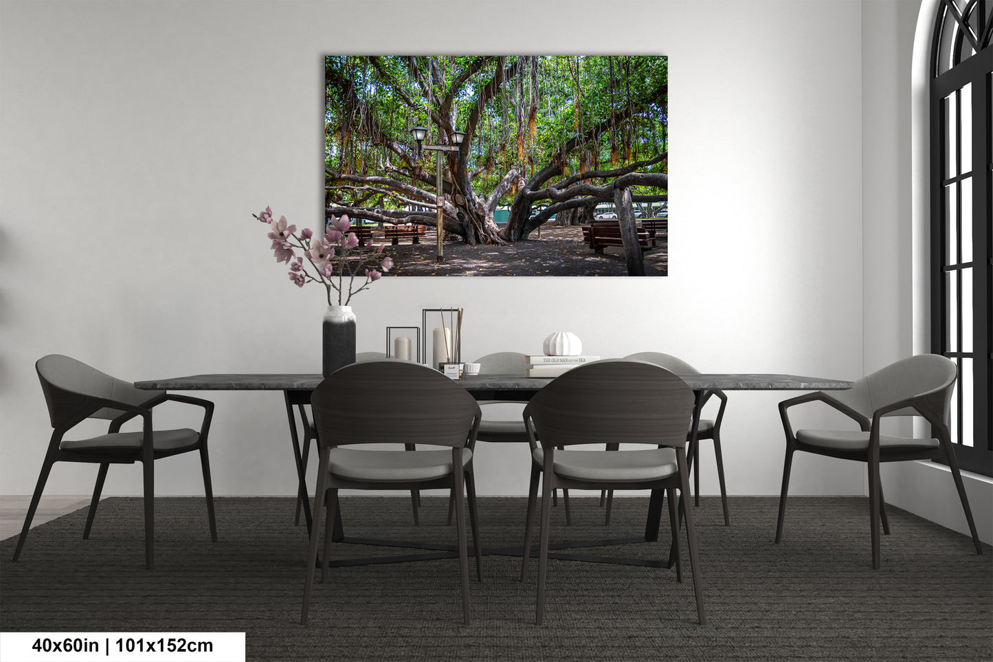 a dining room table with chairs and a painting on the wall