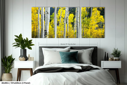 a bed room with a neatly made bed and a painting on the wall