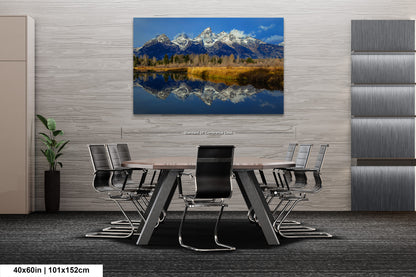 a dining room table with chairs and a painting on the wall