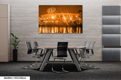 a dining room table with chairs and a picture of a stadium