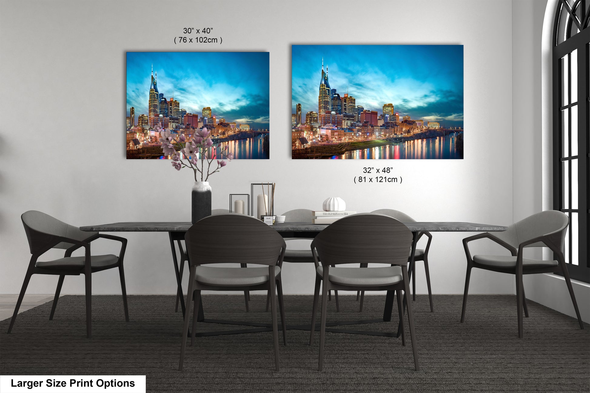 a dining room table with four chairs and a painting on the wall