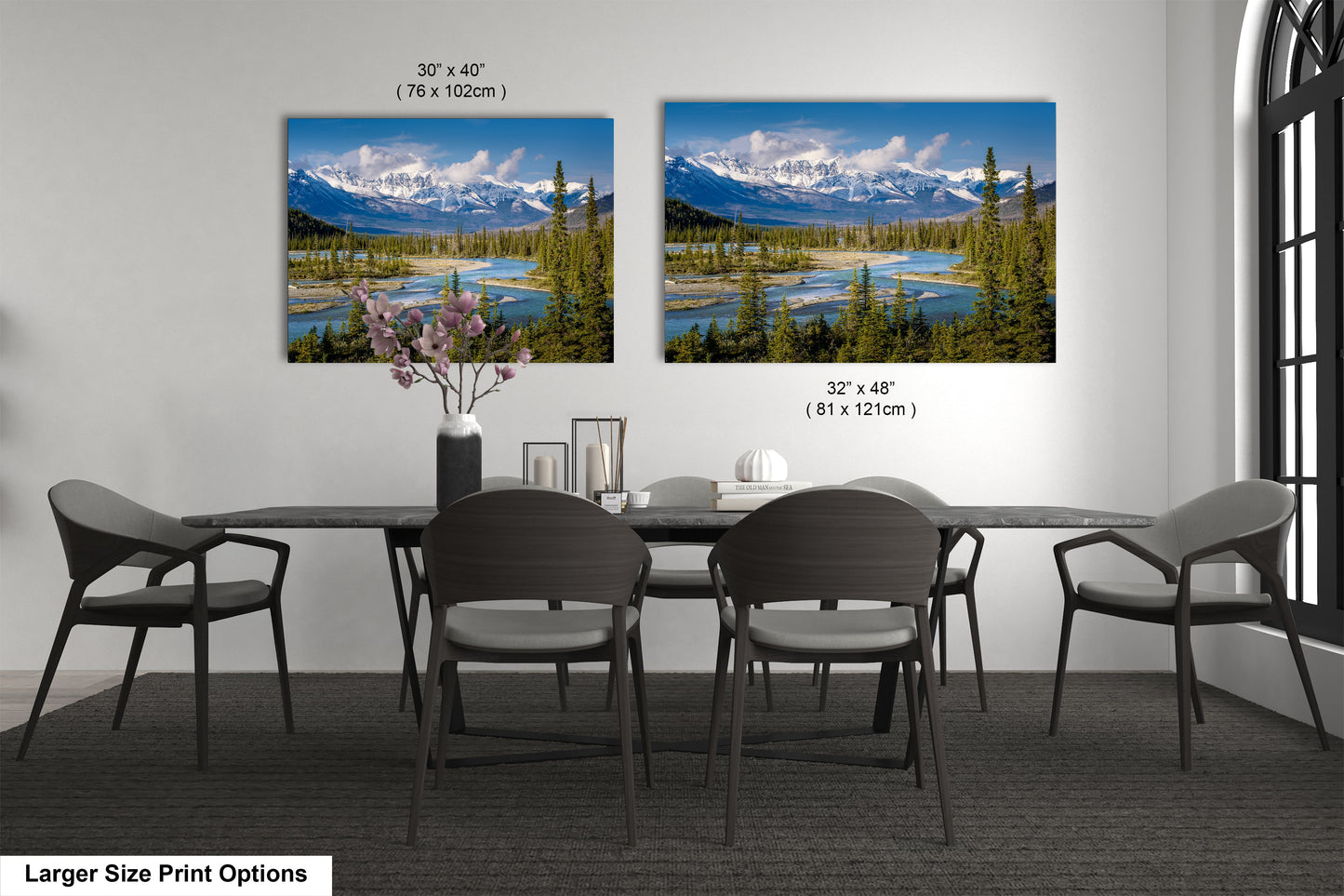 a dining table with four chairs and a vase of flowers
