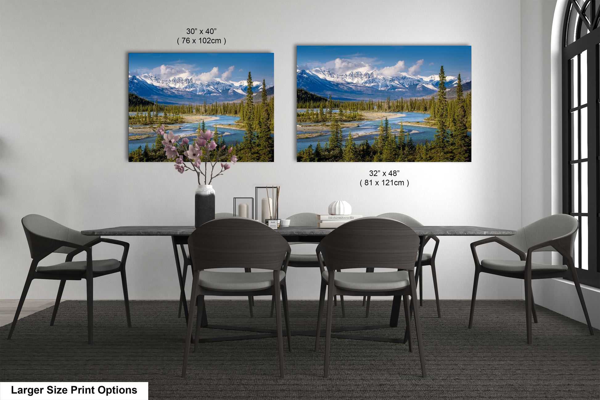 a dining table with four chairs and a vase of flowers