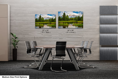 a dining room table with chairs and two pictures of trees
