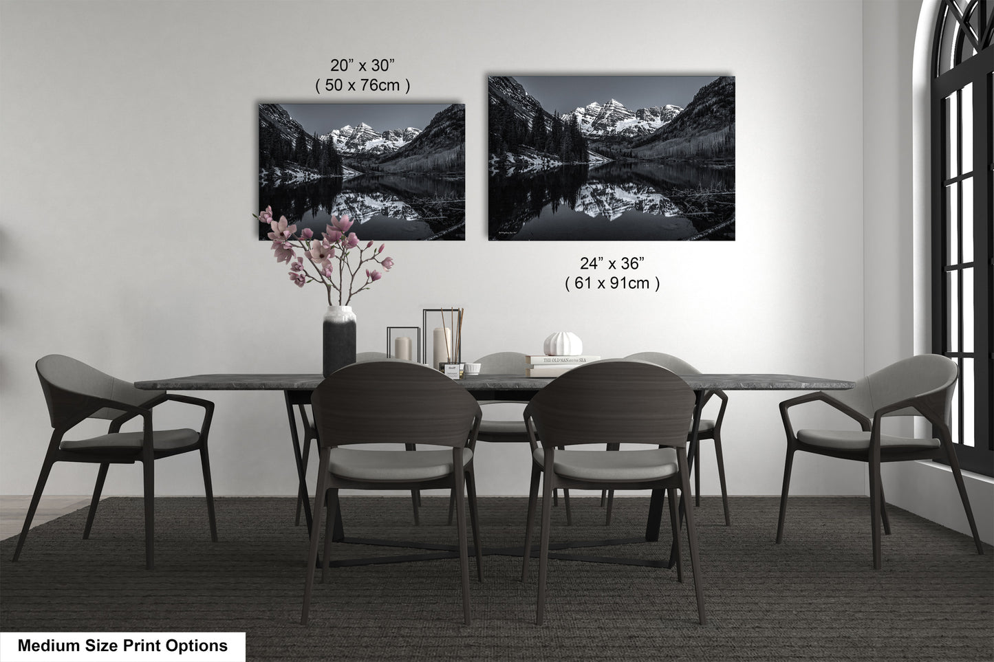 a dining table with four chairs and a vase of flowers