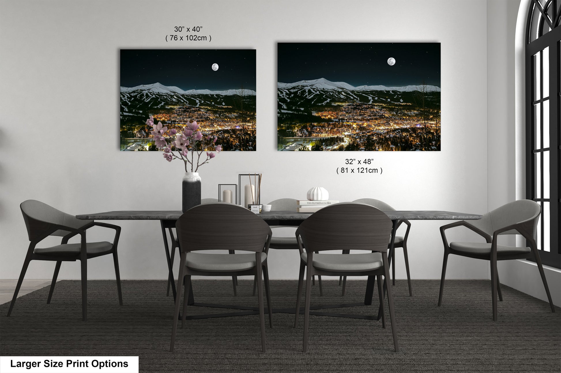 a dining table with four chairs and a vase of flowers
