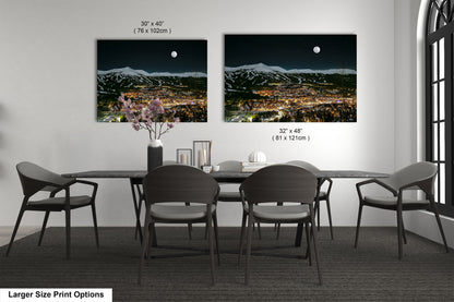 a dining table with four chairs and a vase of flowers