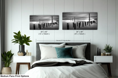 a bed room with a neatly made bed and two pictures on the wall