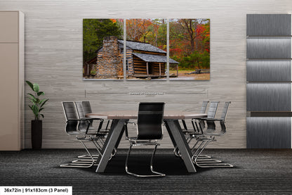 a dining room table with chairs and a log cabin in the background