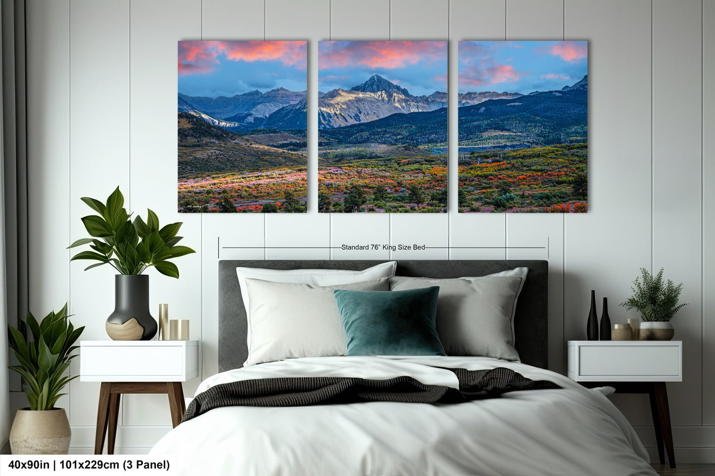 a bedroom scene with a bed and two paintings on the wall