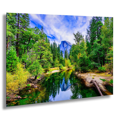 a river surrounded by trees and a mountain in the background