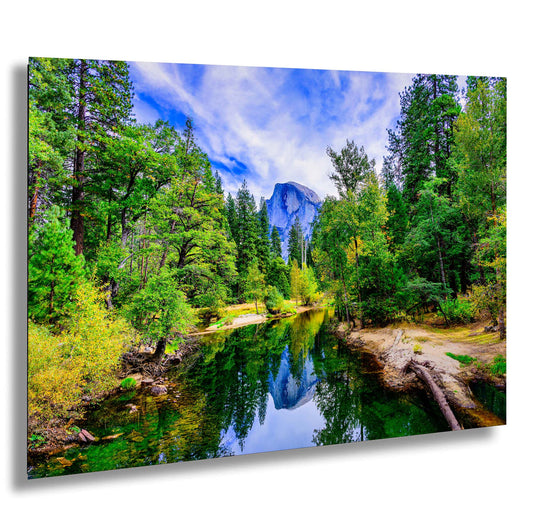 a river surrounded by trees and a mountain in the background