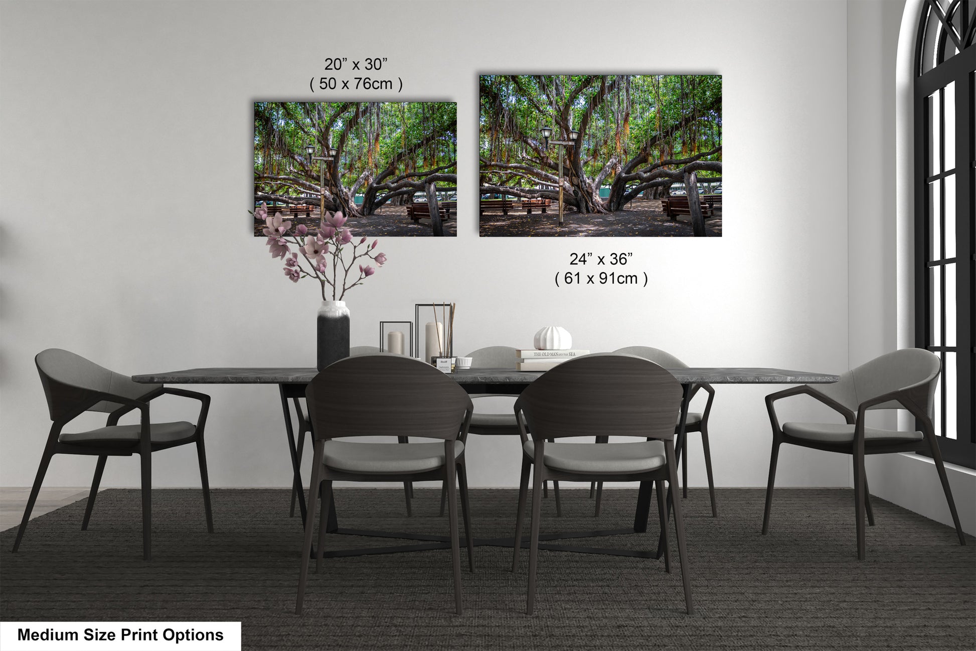 a dining room table with four chairs and a vase with flowers