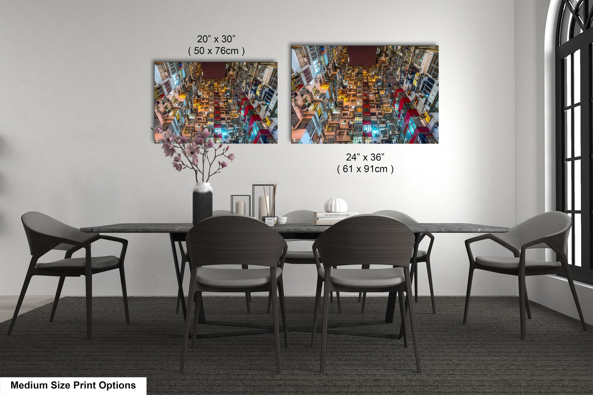 a dining table with four chairs and a vase of flowers