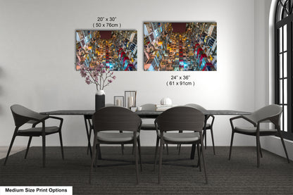 a dining table with four chairs and a vase of flowers