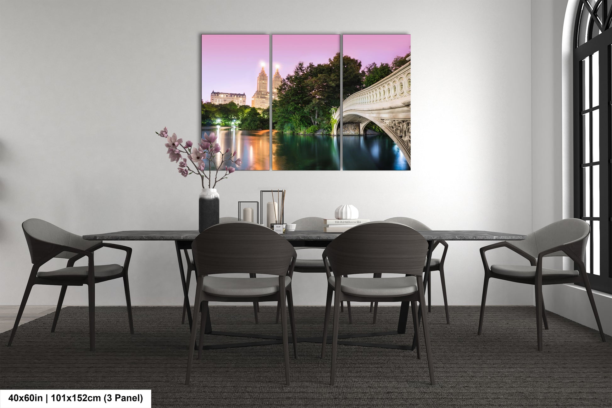 a dining room table with chairs and a painting on the wall