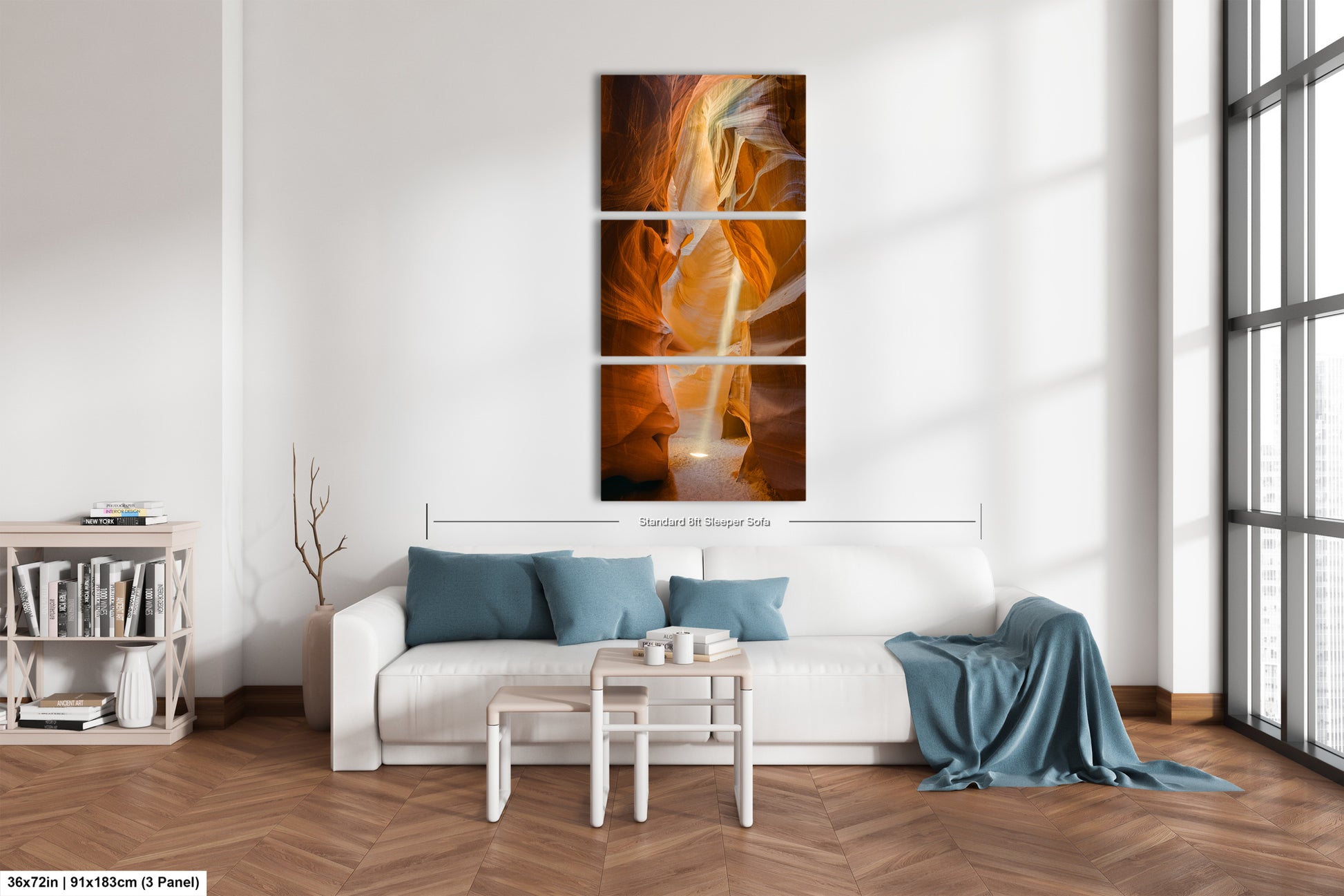 a living room with a white couch and a painting on the wall