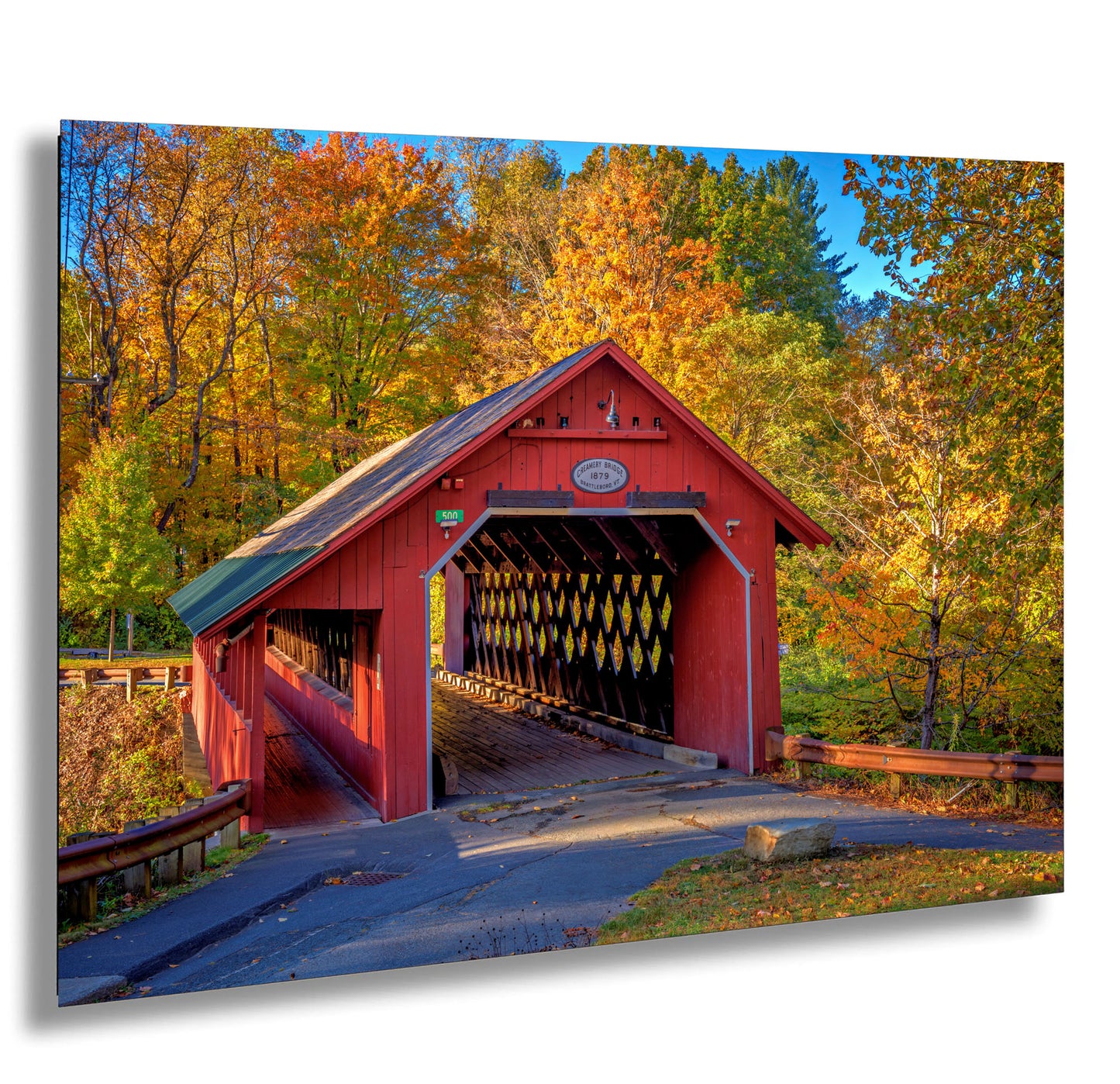 a red covered bridge in a wooded area