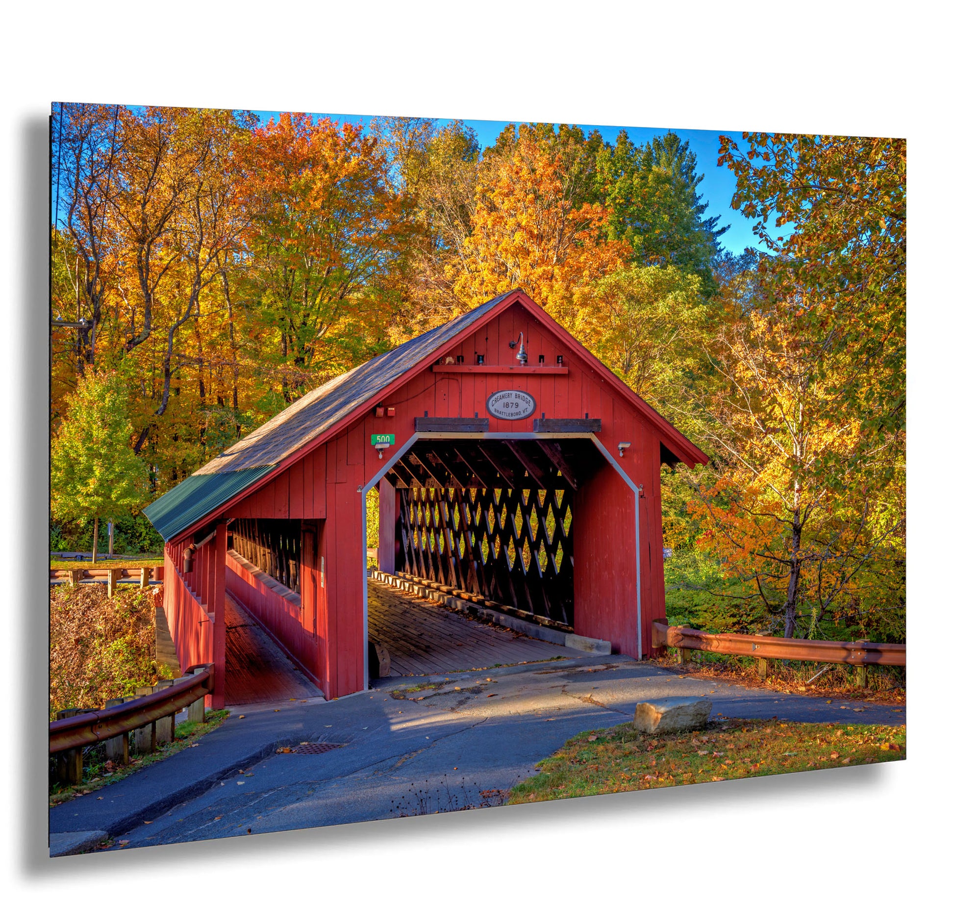 a red covered bridge in a wooded area