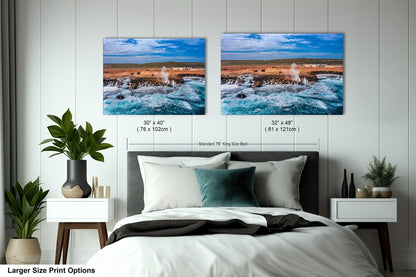 a bedroom with a bed and two pictures on the wall