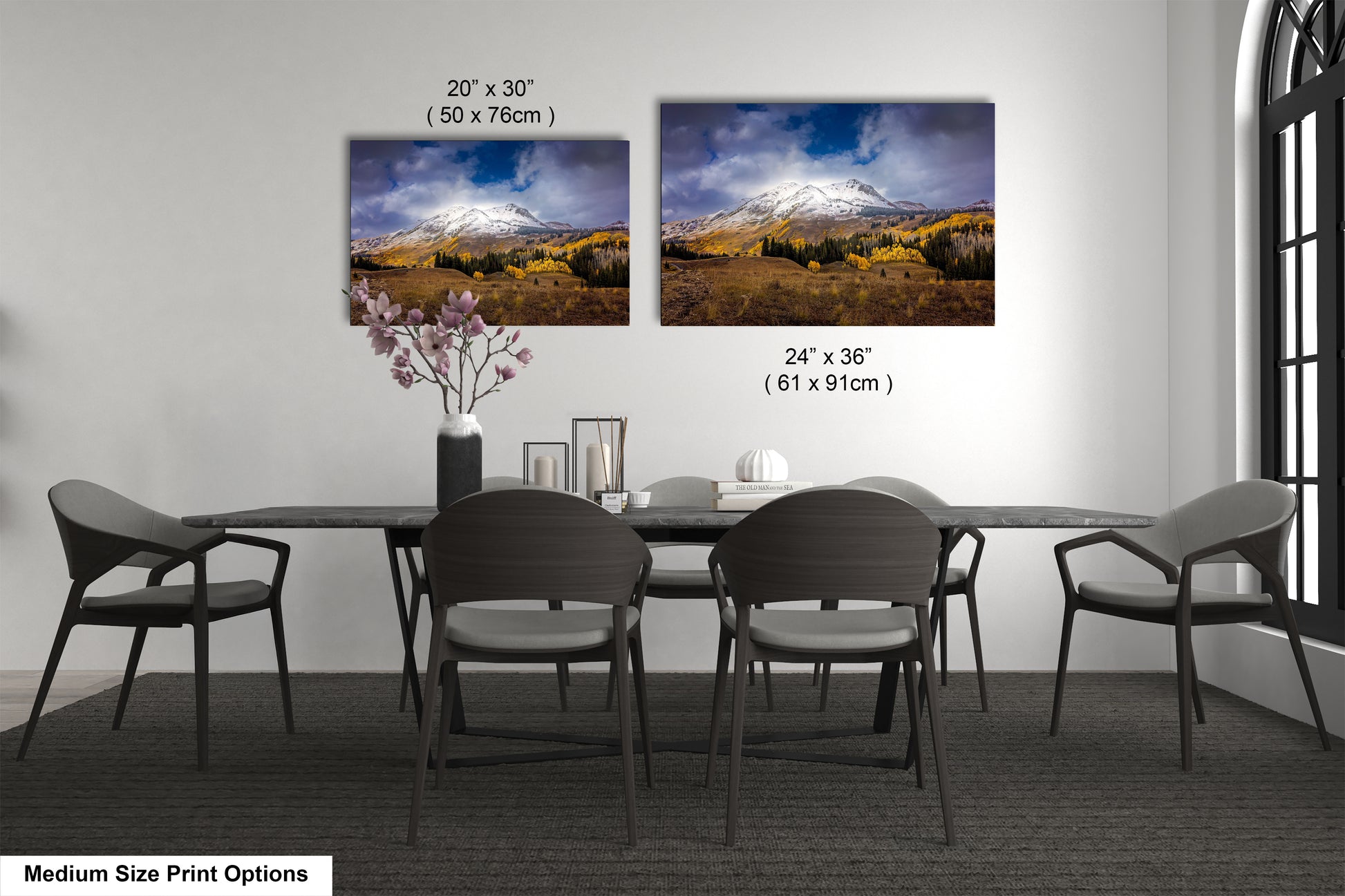 a dining room table with four chairs and a vase with flowers
