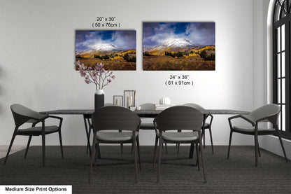 a dining room table with four chairs and a vase with flowers