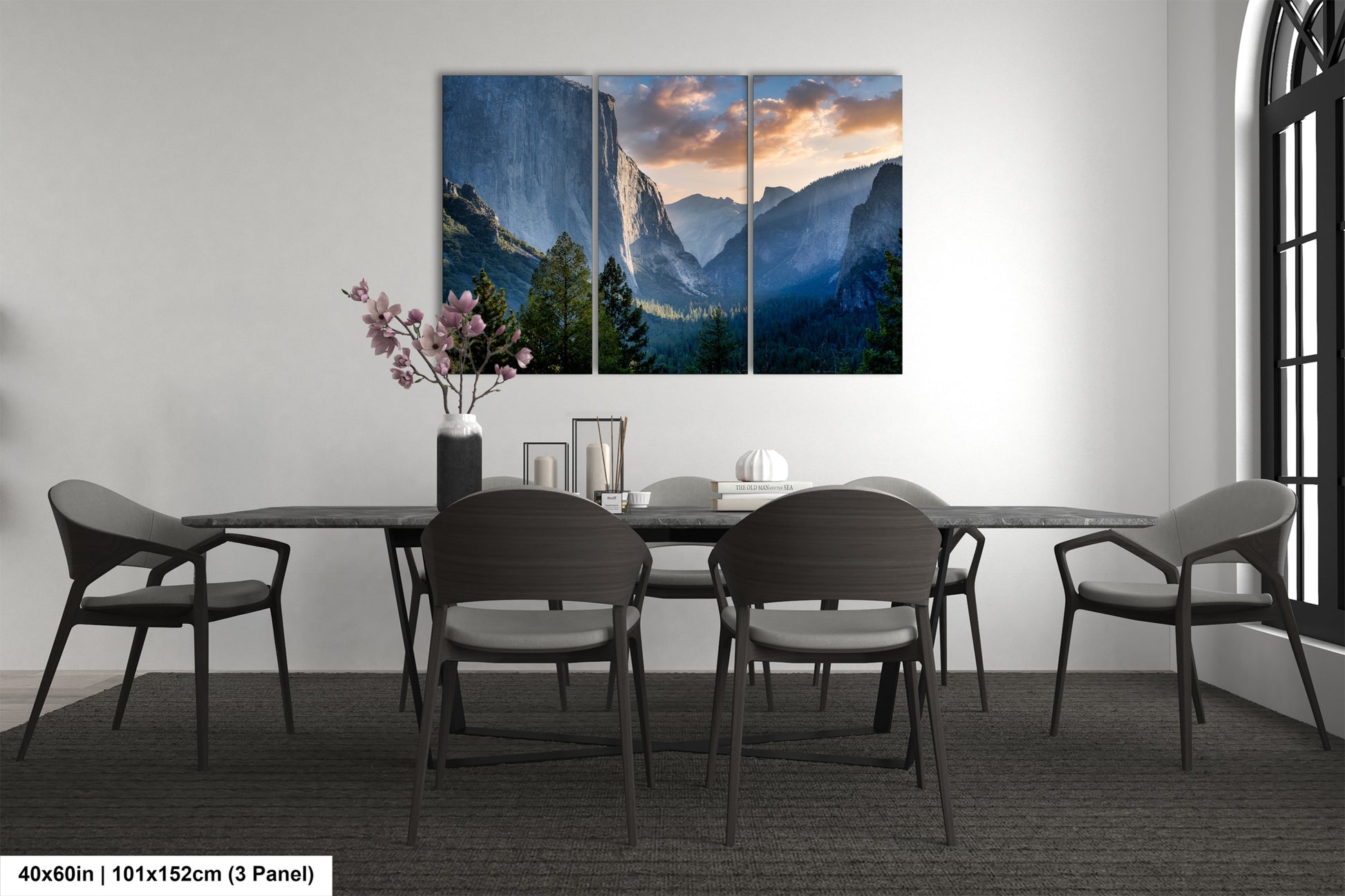 a dining room table with chairs and a painting on the wall