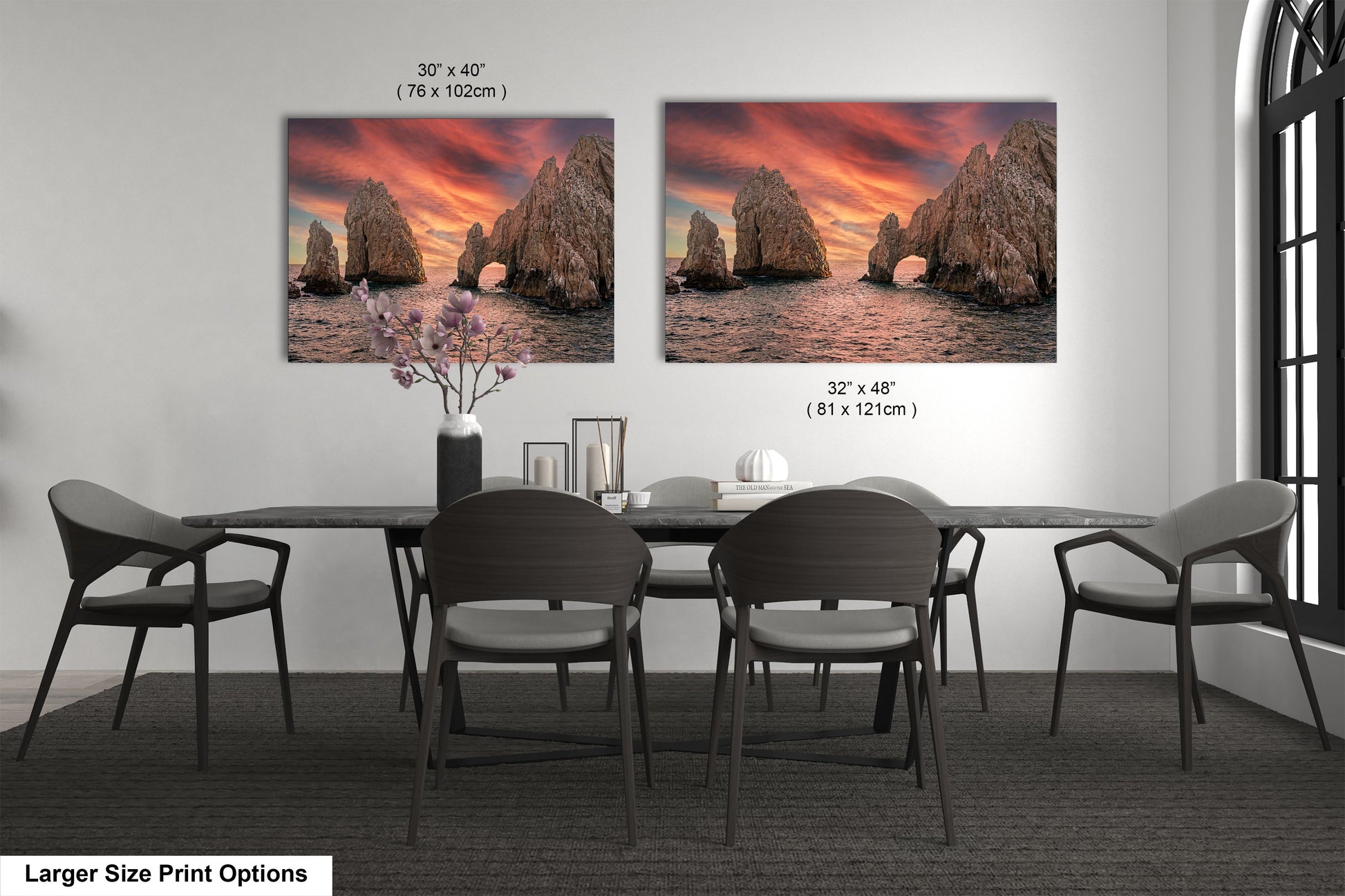 a dining room table with four chairs and two pictures on the wall