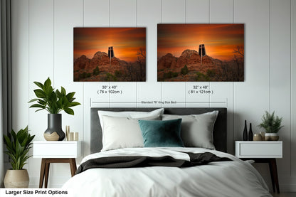 a bedroom with a bed and two pictures on the wall