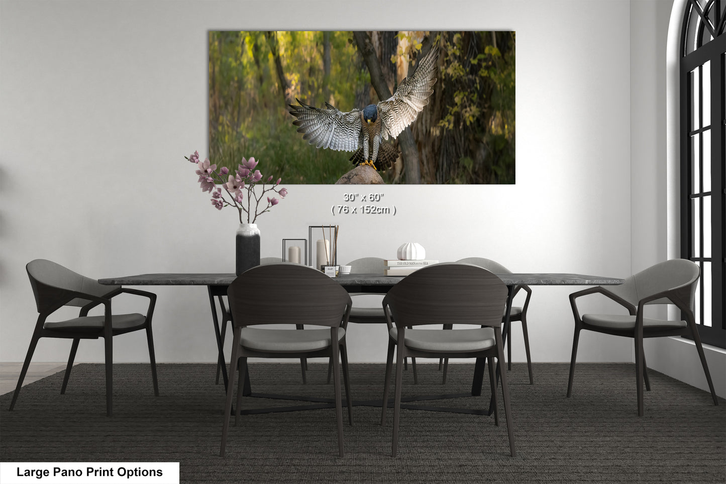 A large pano print depicting a bird in flight with its wings spread wide, set against a backdrop of trees and foliage.