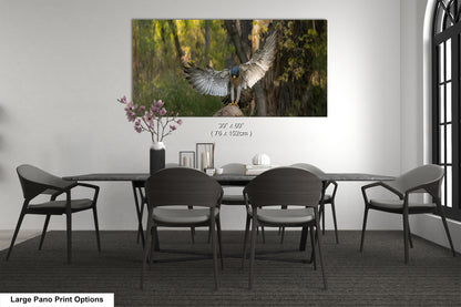 A large pano print depicting a bird in flight with its wings spread wide, set against a backdrop of trees and foliage.
