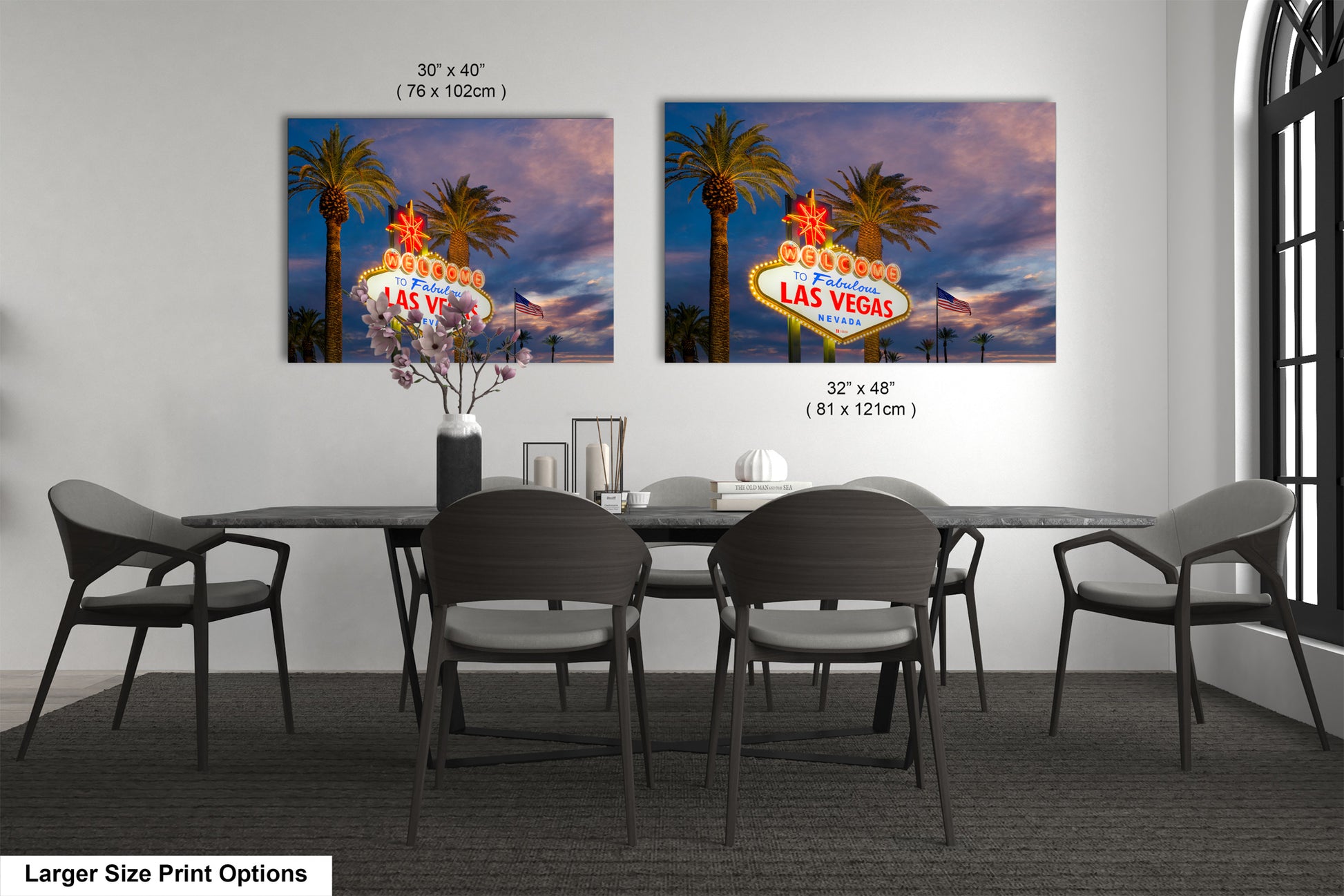 a dining room table with four chairs and a large picture of the las vegas sign