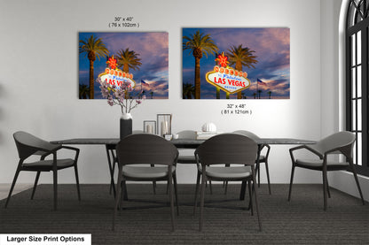 a dining room table with four chairs and a large picture of the las vegas sign