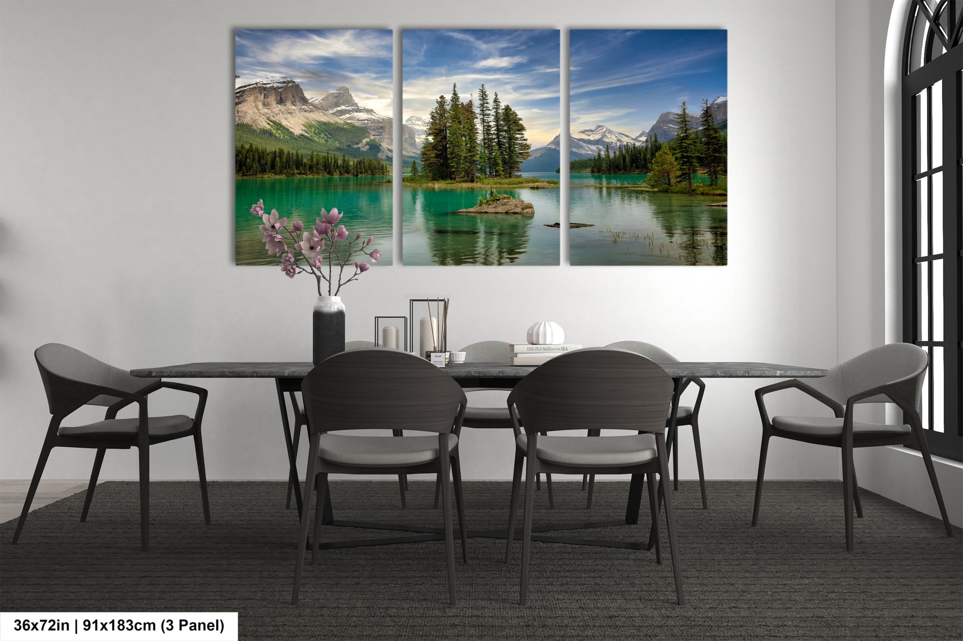 a dining room table with chairs and a painting on the wall