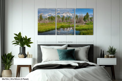a bed room with a neatly made bed and a painting on the wall