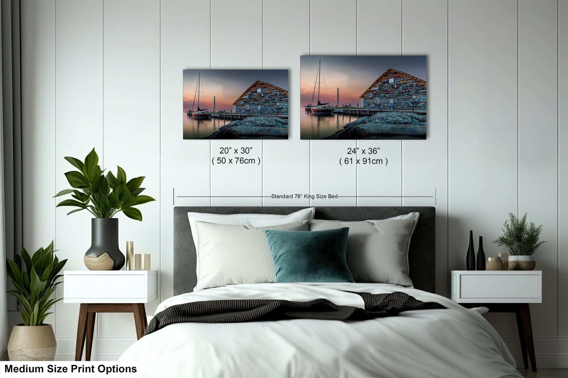 a bedroom with a bed, nightstands, and potted plants. There are two framed prints hanging on the wall above the bed, depicting a seascape with a building and boats. The prints are of different sizes, ranging from 24" x 36" to 50" x 70" (71" x 91").