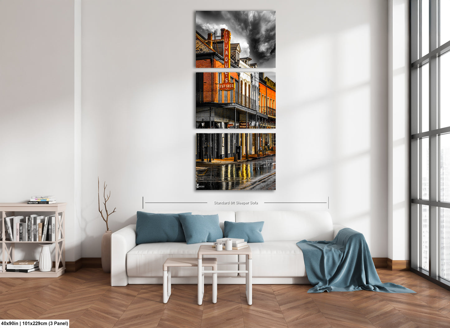 a living room with a white couch and a painting on the wall