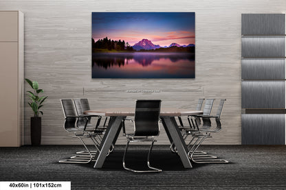 a dining room table with chairs and a painting on the wall