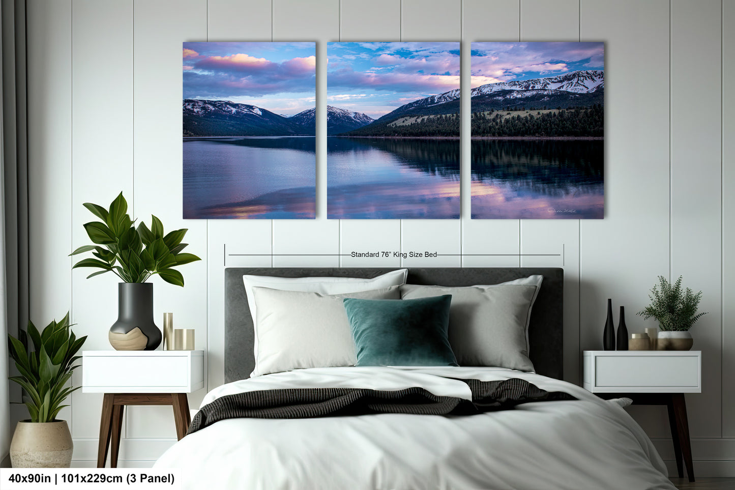 a bedroom with a bed and two paintings on the wall