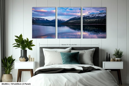a bedroom with a bed and two paintings on the wall
