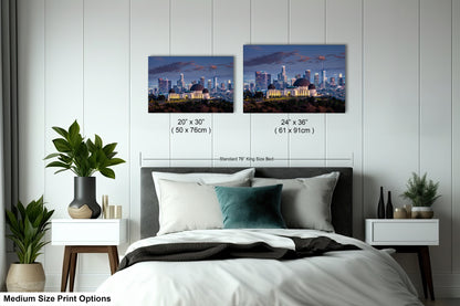 a bedroom with a bed and two pictures on the wall