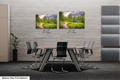 a dining room table with chairs and two pictures on the wall