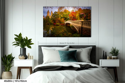 a bedroom with a large bed, nightstands, and a painting of a bridge and trees hanging on the wall.