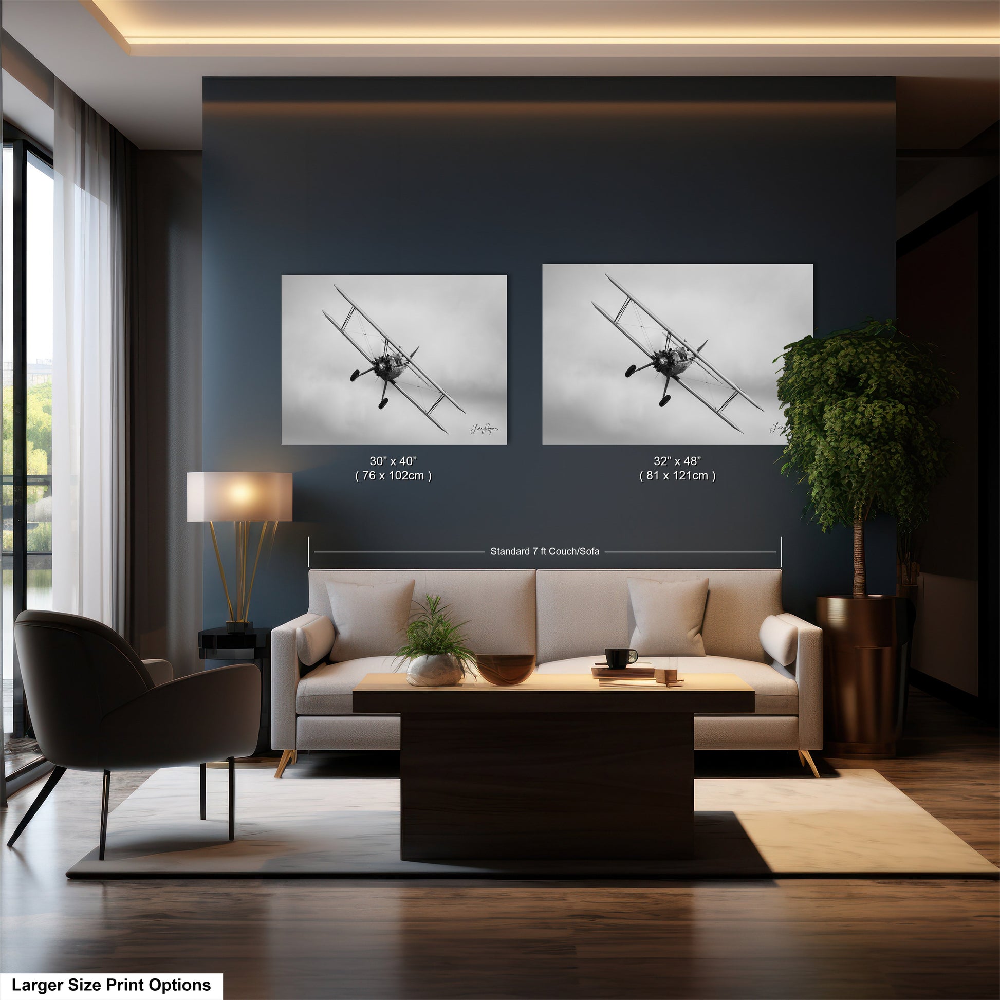 a living room with a couch a chair and two pictures on the wall