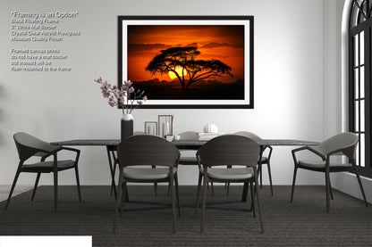a picture of a table with chairs and a vase of flowers