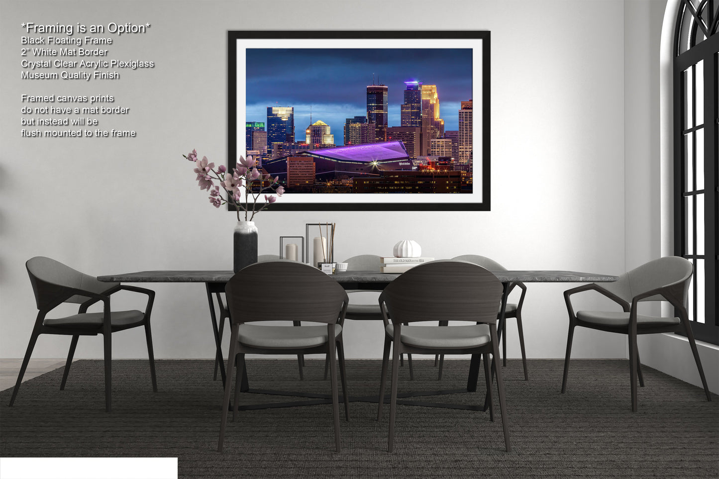 a dining room table with chairs and a picture hanging on the wall