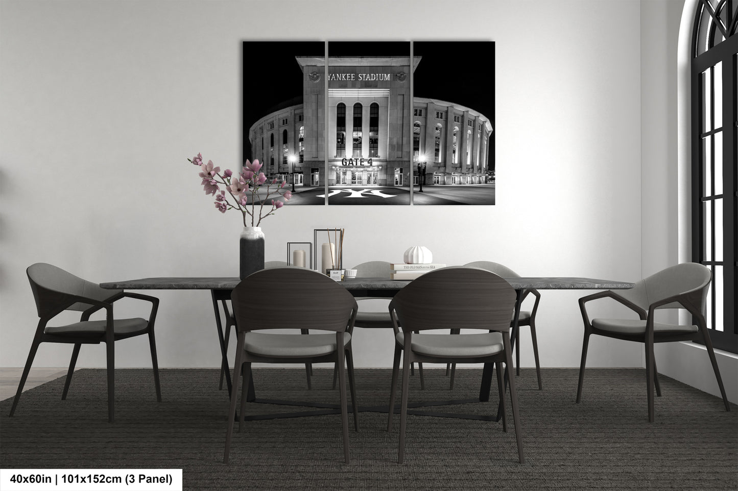 a modern dining room with a large black and white photograph of Yankee Stadium hanging on the wall above a wooden dining table with six chairs.