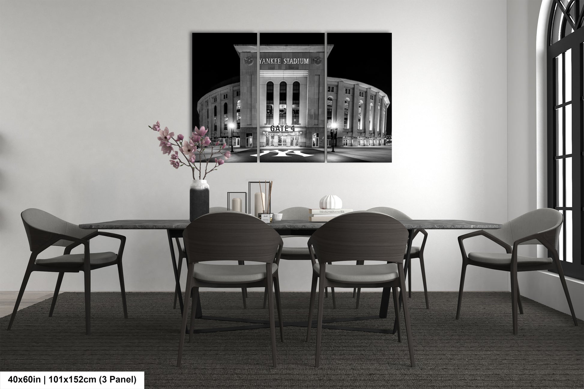 a modern dining room with a large black and white photograph of Yankee Stadium hanging on the wall above a wooden dining table with six chairs.