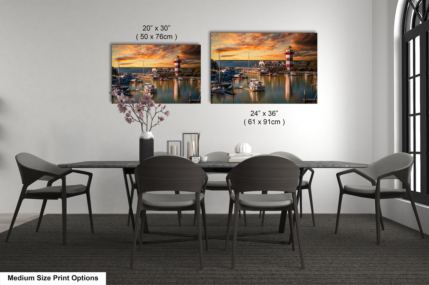 a dining table with four chairs and a vase of flowers