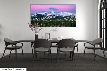 a dining room table with chairs and a painting on the wall